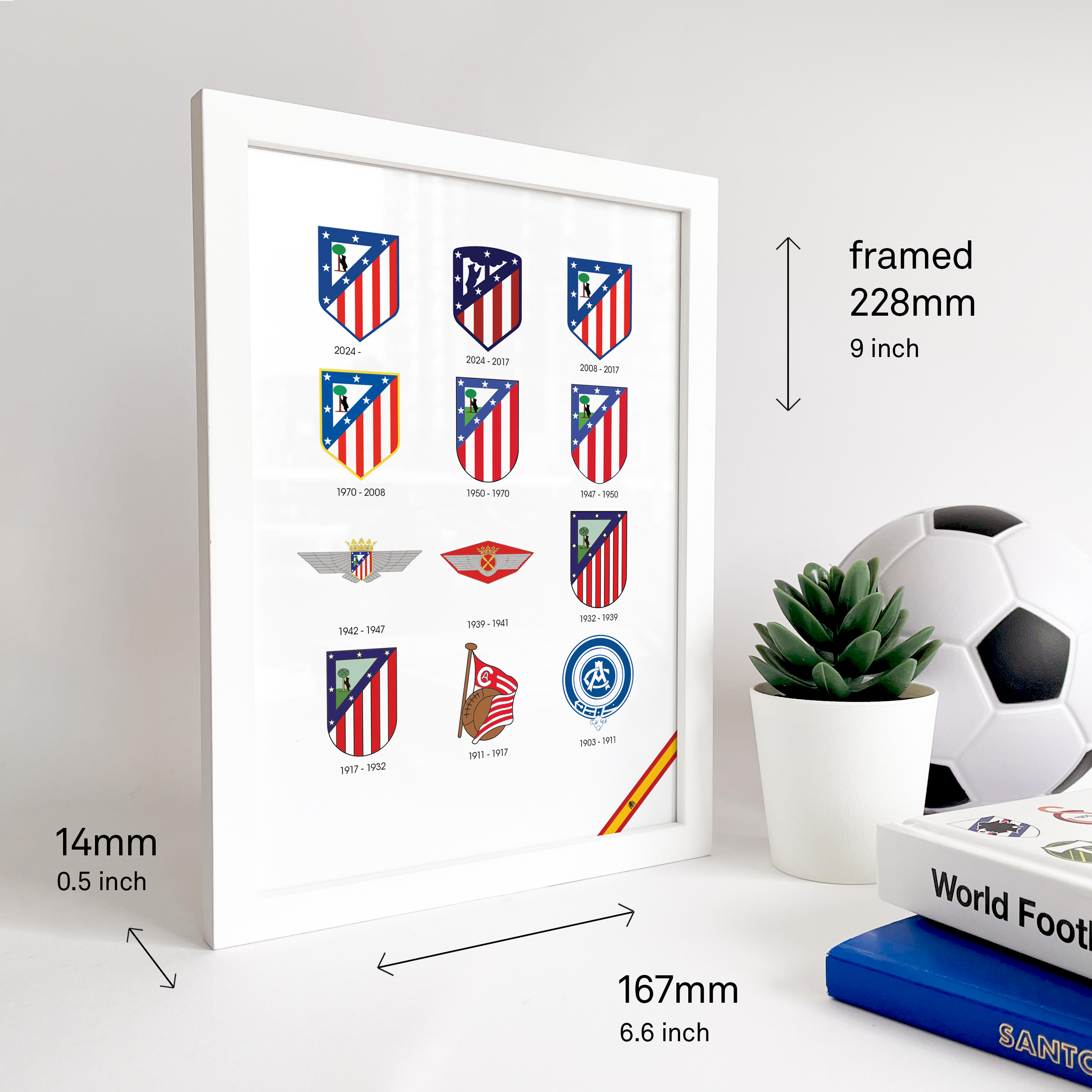 Atletico Madrid Logo History print. Next to the frame two football books and a ball is visible.