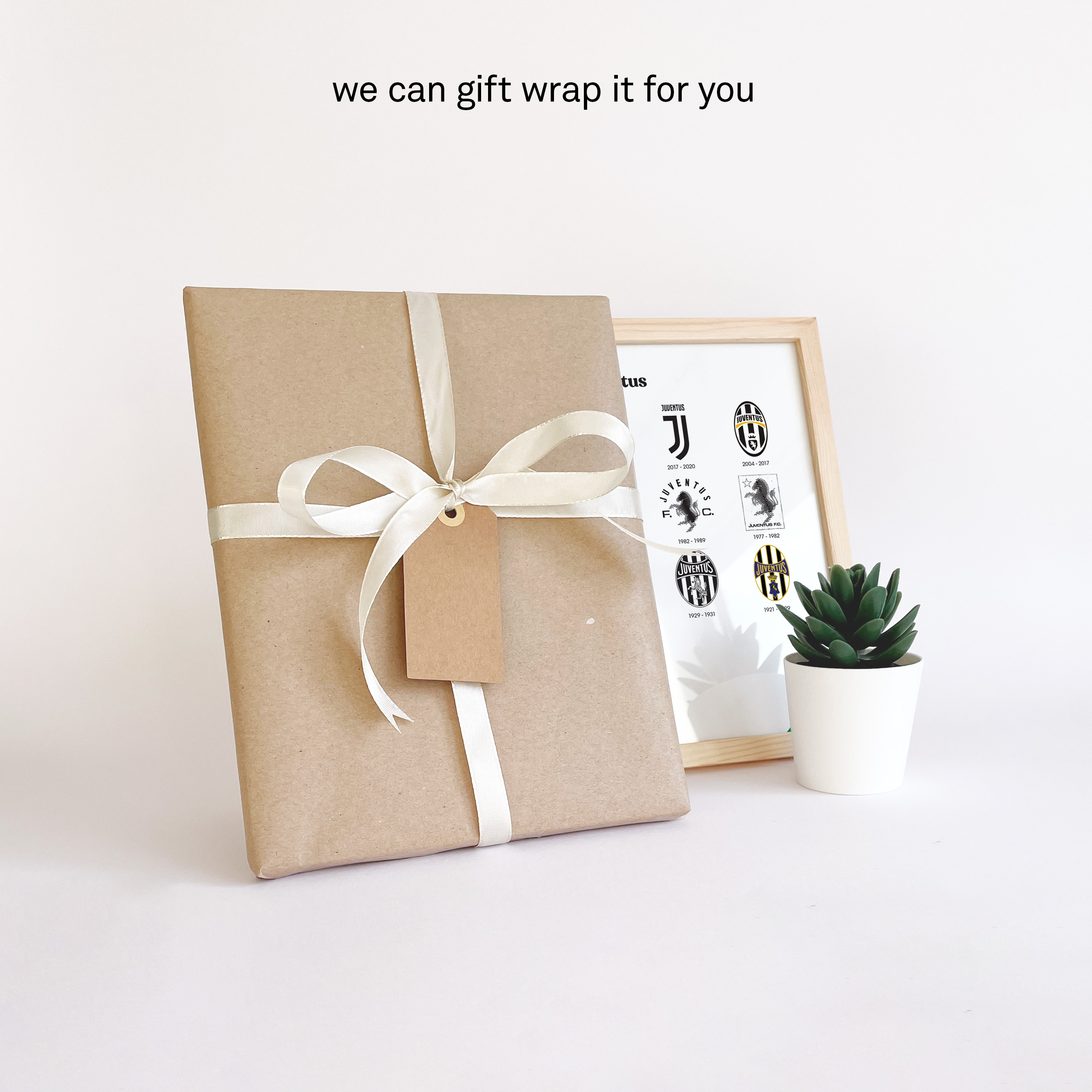 Arsenal Logo History print giftwrapped in brown durable paper with a white ribbon and a personal note card so you can send it directly to that special person